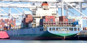 Large Ship in port with shipping containers.