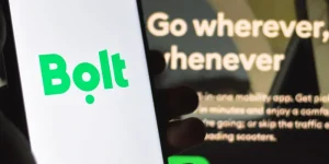 Close-up of a smartphone displaying the Bolt app logo, representing the Bolt driver compensation claim securing worker rights and backpay for UK drivers.
