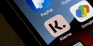 Close-up of a smartphone screen showing Klarna and PayPal apps, symbolising the need for Buy Now, Pay Later regulation to protect consumers in the UK.