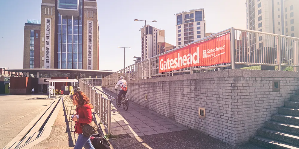 Gateshead city scene with a council banner – find out how to claim Gateshead data breach compensation.
