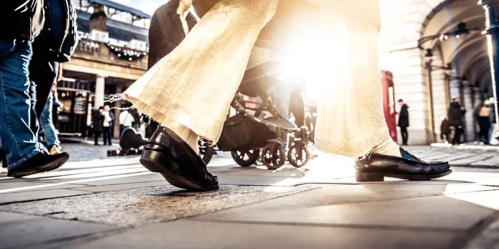 Low-angle view of people walking in a city, symbolising unity and collective action, related to key facts about group litigation for seeking justice.