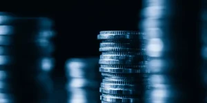 Close-up of stacked coins symbolising financial losses from financial mis-selling, highlighting the need for compensation through group litigation.