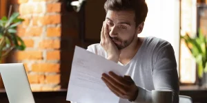 Worried individual checking documents after the Gateshead Council data breach – understanding risks and protecting personal data.