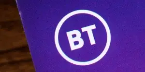 Close-up of the BT logo, pictured on an information leaflet. The BT Group are a British multinational telecommunications holding company.