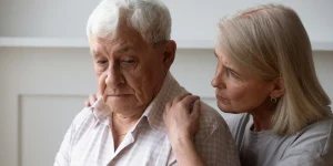 Loving middle-aged woman comforts sad distressed elderly 80s man feeling loneliness,