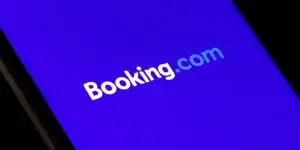 Booking.com logo displayed on the smartphone, travel and hotel industry