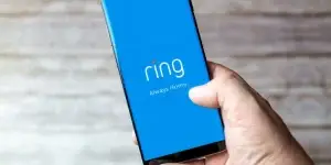 Mobile phone or cell phone being held showing the Ring doorbell app open on screen