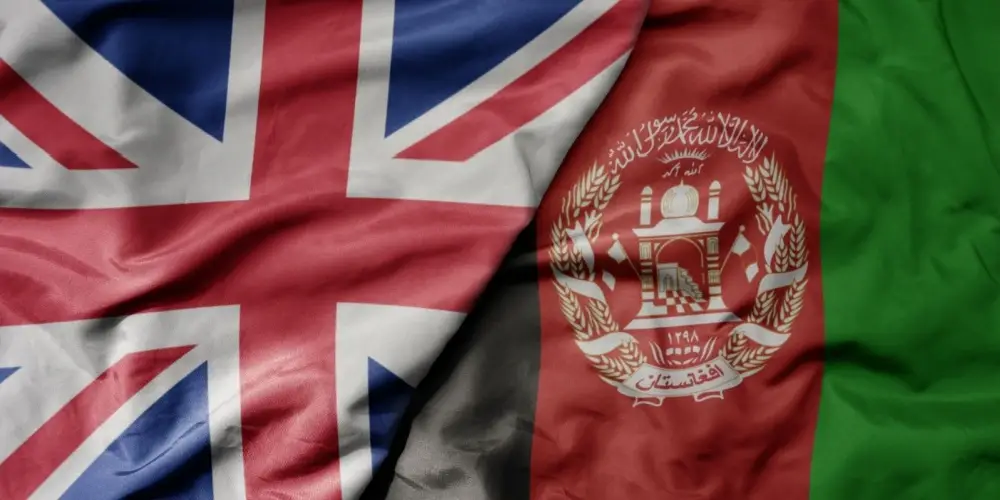 big waving national colorful flag of great britain and national flag of afghanistan