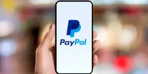 hand holding phone with PayPal apps on the screen.
