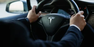 Tesla X car interior with touchscreen monitor display, illuminated car dashboard with different navigating and informative apps.