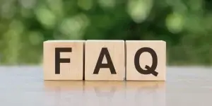 FAQ letter on block cubes on wooden table over blur green tree in park, Frequently asked questions about group action claims