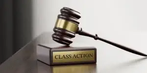 Class Action: Judge's Gavel as a symbol of legal system and wooden stand with text word.