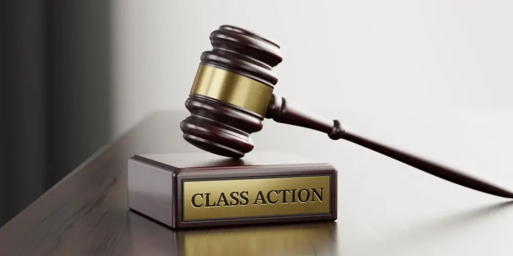 Class Action: Judge's Gavel as a symbol of legal system and wooden stand with text word.