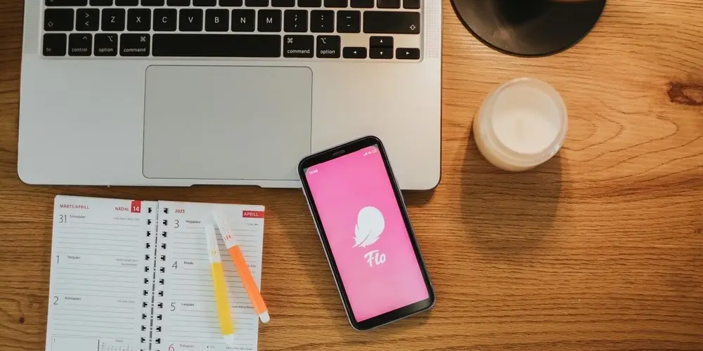 Working wooden table with Flo logo on the phone screen
