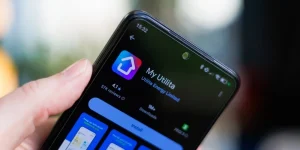 A close-up of a person's hand holding a smartphone displaying My Utilita