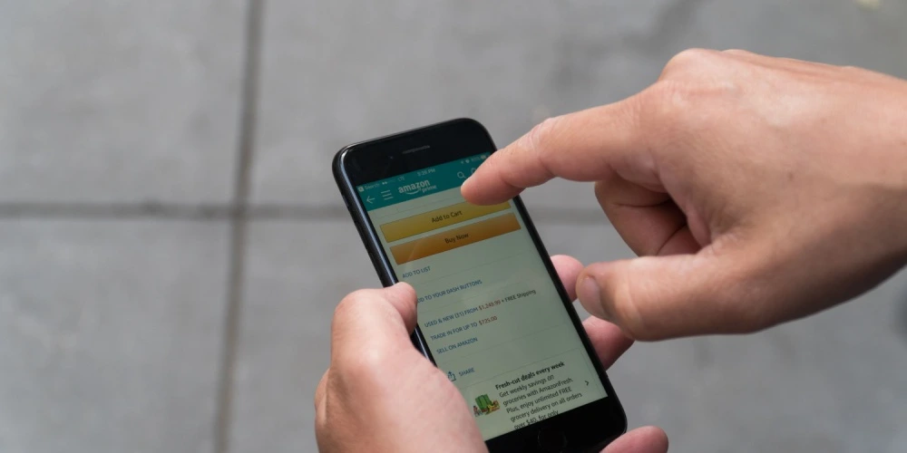 Man uses iPhone to purchase goods on Amazon buy box on phone app